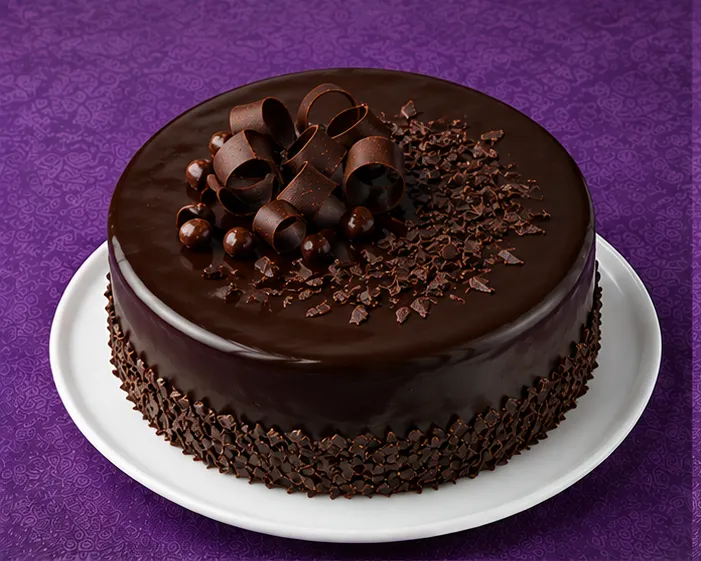 Chocolate cake with glossy ganache and chocolate curls