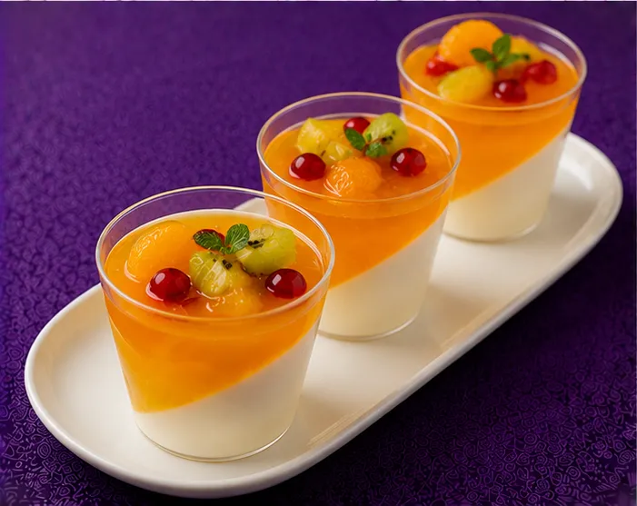 Orange jelly dessert with kiwi and red berries