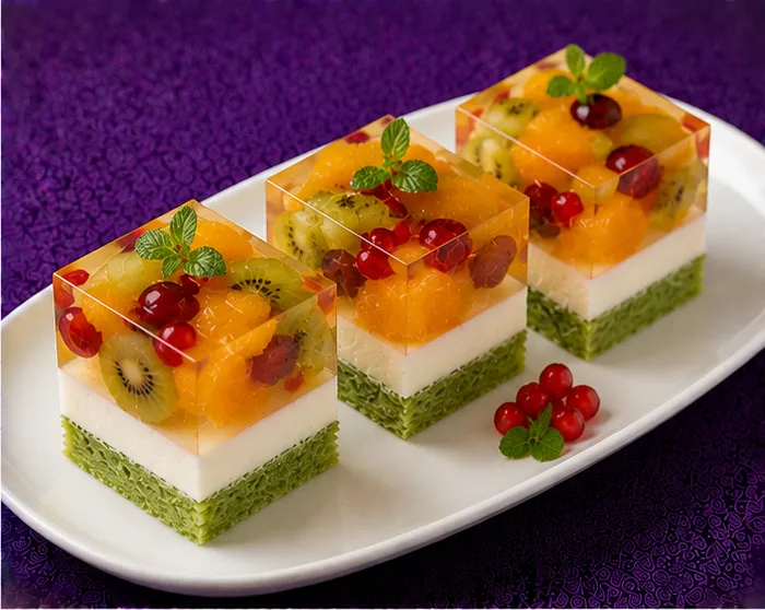 Kiwi, orange and red currant jelly dessert with cream